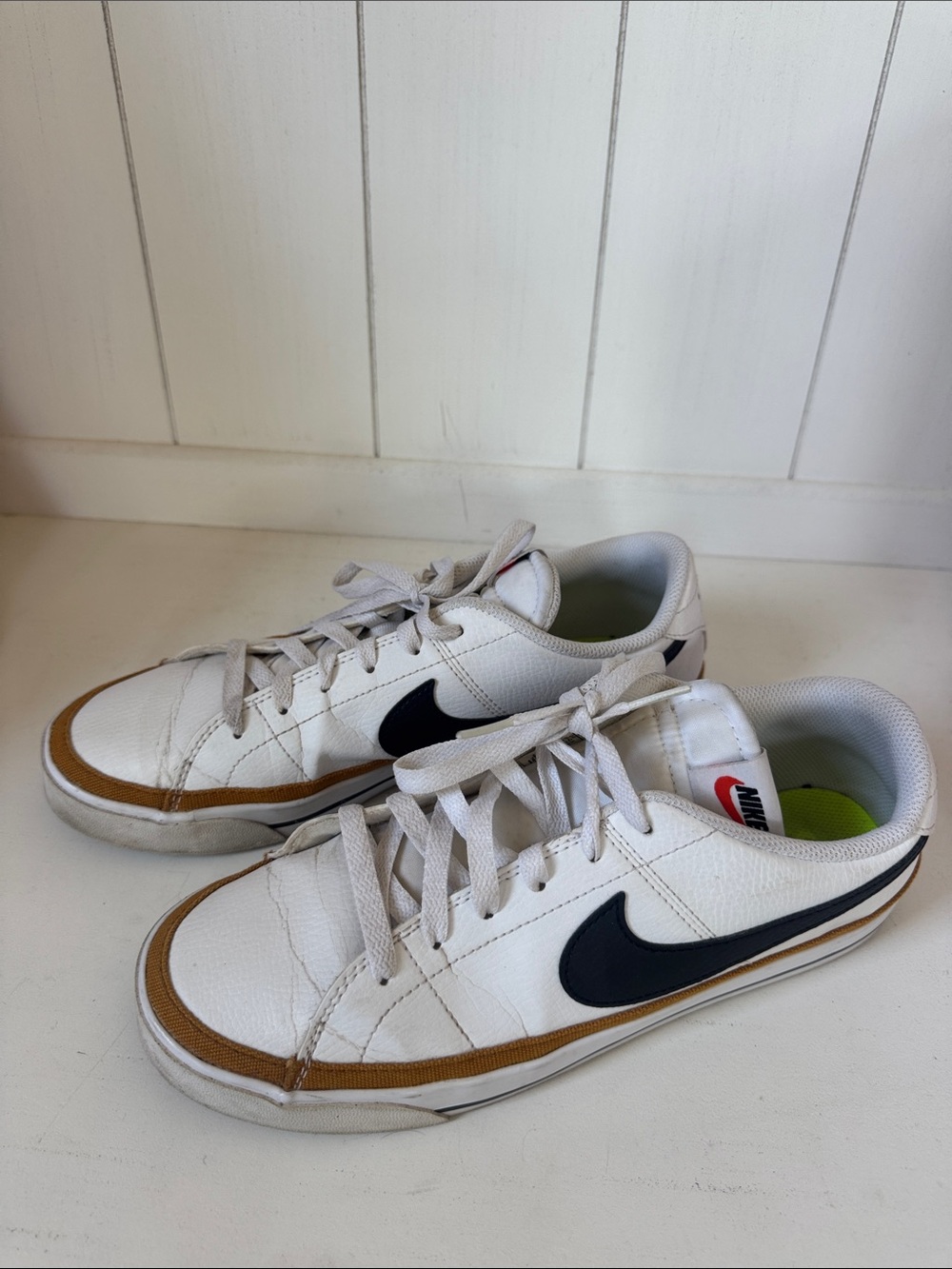 Nike White Low-Top Sneakers with Black Swoosh and Brown Trim